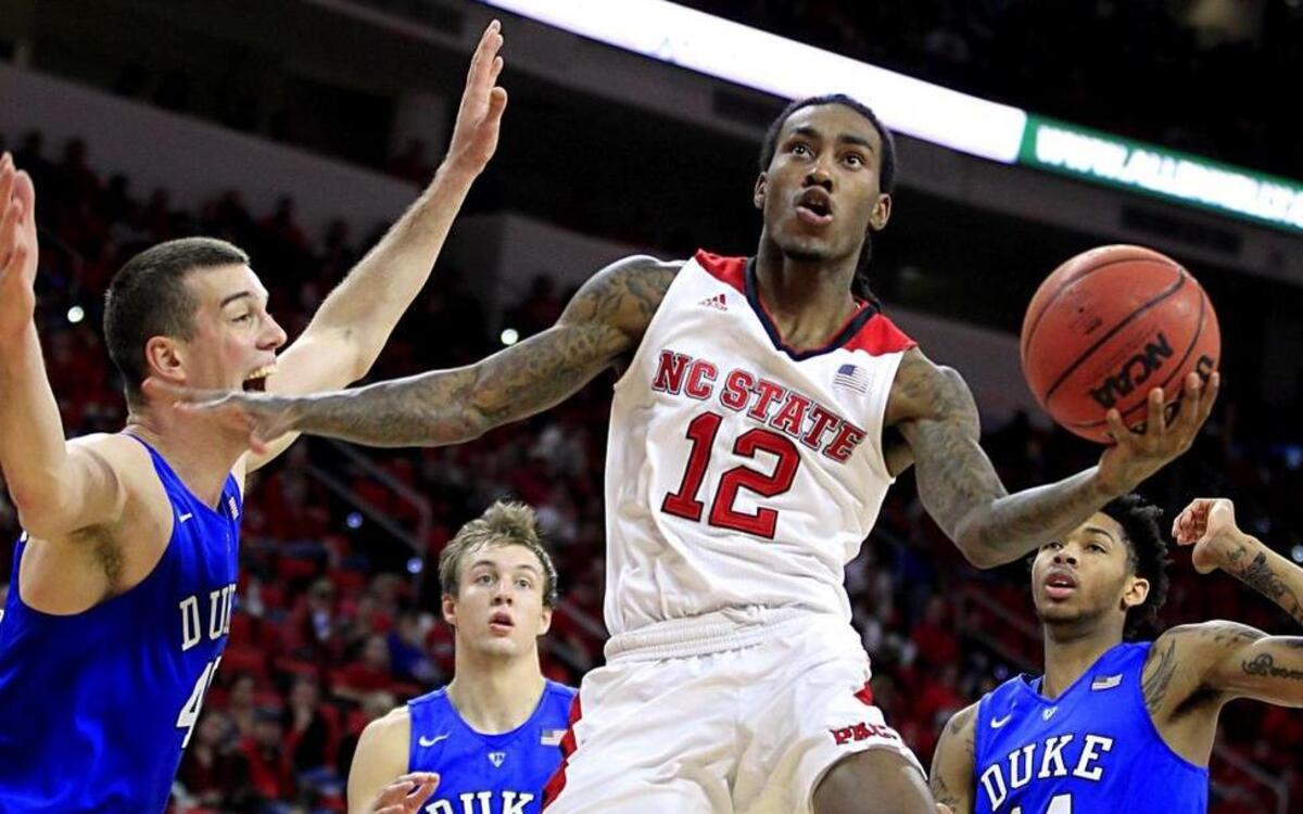 N.C. State’s Cat Barber (12) drives to the basket past Duke’s Marshall Plumlee (40) during the second half of Duke’s 88-78 win over the Wolfpack Saturday. After Barber tweaked his knee in the second half, N.C. State’s offense cooled.