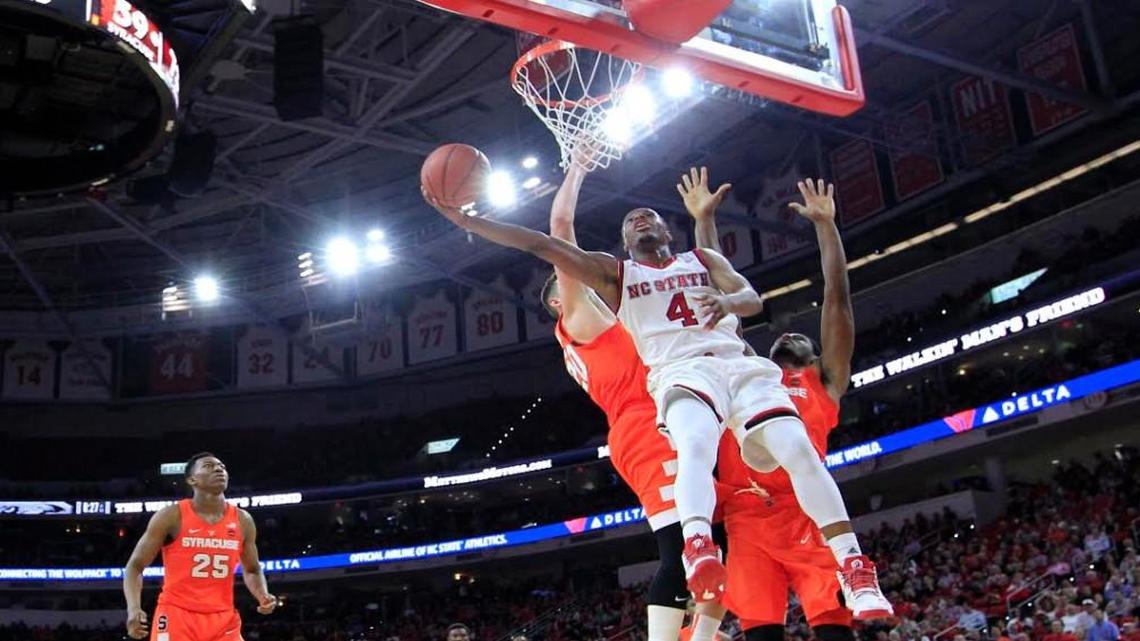 N.C. State's Dennis Smith Jr. (4) makes a basket as Syracuse's Tyler Lydon (20) and Taurean Thompson (12) guard him in the second half during Syracuse's 100-93 overtime victory over N.C. State at PNC Arena in Raleigh on Wednesday, Feb. 1, 2017.