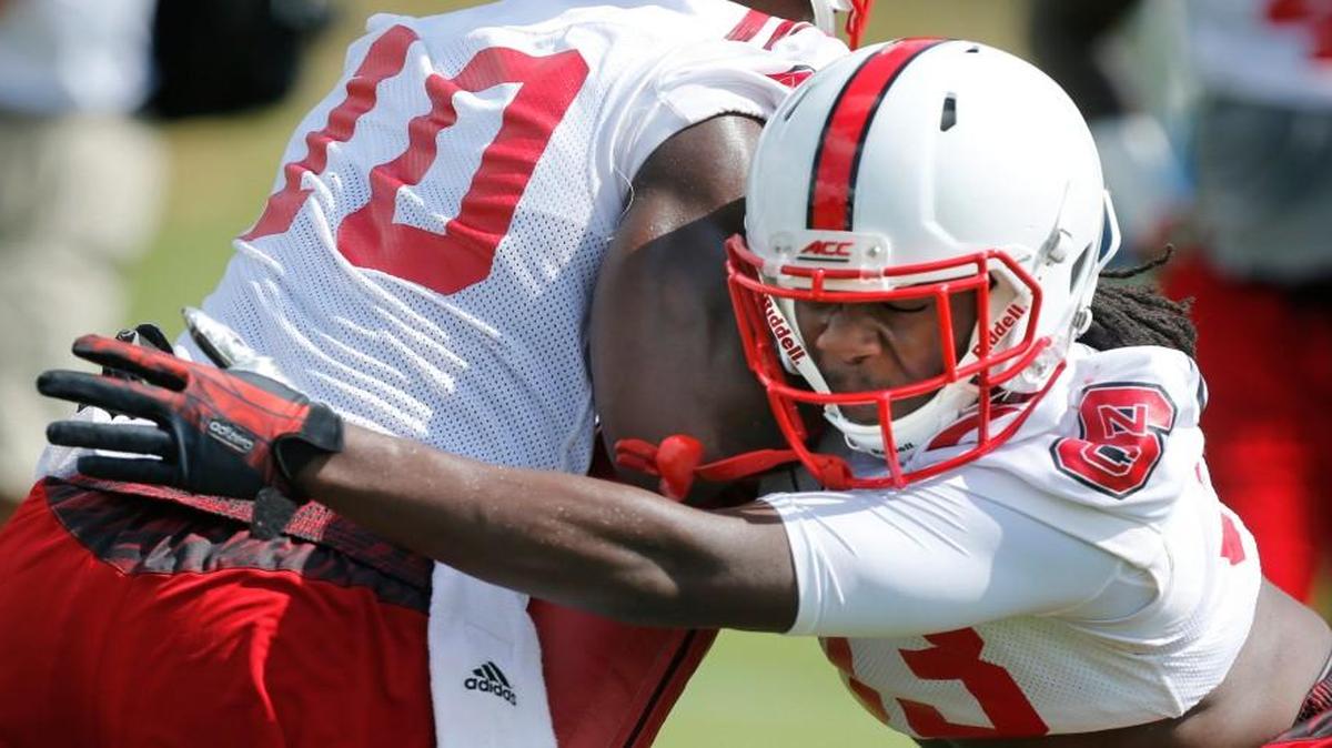 
N.C. State's Charlie Twitty (33), right, hits Freddie Phillips, Jr. (10) during the Wolfpack's first preseason practice Tuesday, August 4, 2015, in Raleigh, N.C.
