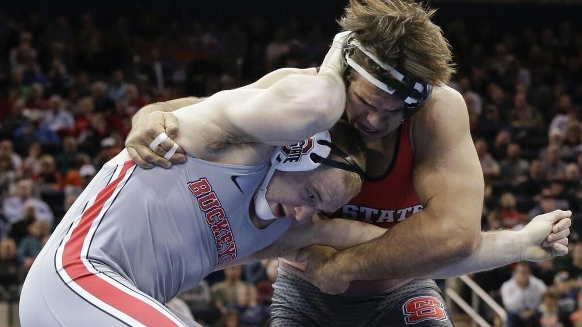 Ohio State’s Kyle Snyder, left, battles N.C. State’s Nick Gwiazdowski in the 285-lb. championship match of the NCAA wrestling championship.