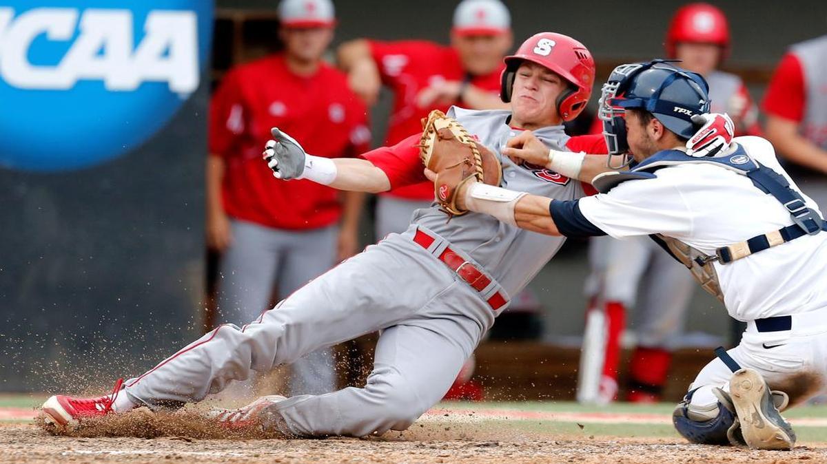 
Rice's Hunter Kopycinski (4) tags out N.C. State's Logan Ratledge (6) as he tries to score on a sacrifice fly in the seventh inning in the second game of the Raleigh Super Regional Sunday, June 9, 2013, at Doak Field in Raleigh, N.C.
