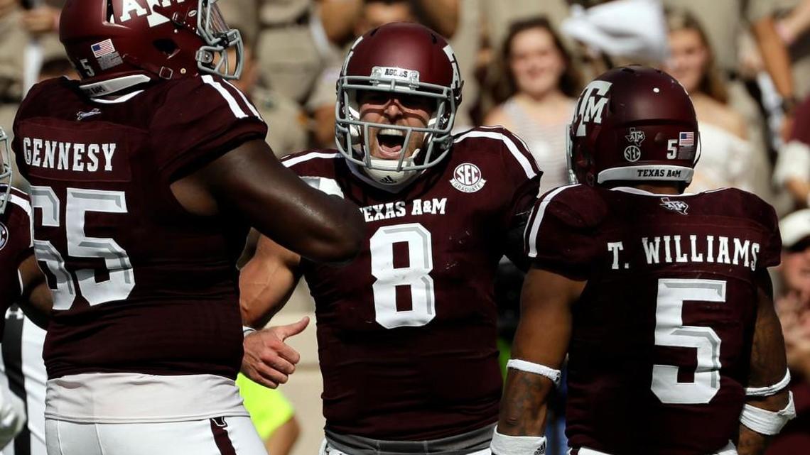 Texas A&M quarterback Trevor Knight (8) celebrates with teammates after rushing for a touchdown against Tennessee on Oct. 8 in College Station, Texas. Texas A&M was ranked fourth behind Alabama, Clemson and Michigan in the season's first College Football Playoff rankings, announced Tuesday. (AP Photo/David J. Phillip, File)