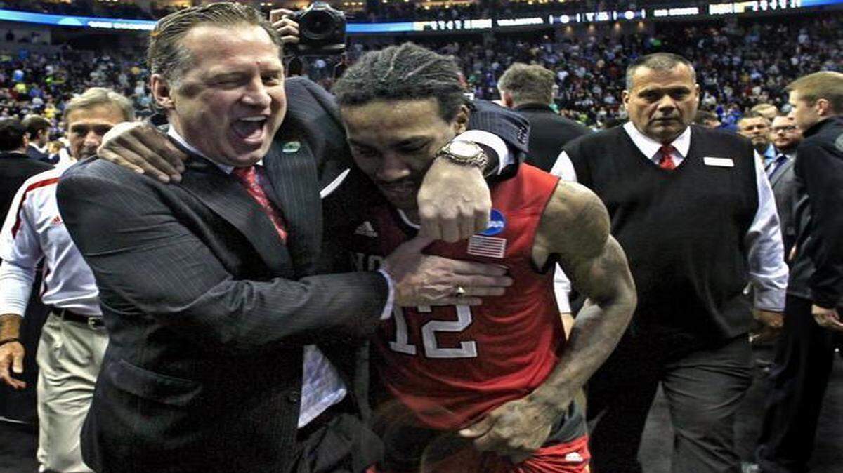 
N.C. State coach Mark Gottfried celebrates with Cat Barberafter the Wolfpack's 71-68 victory over Villanova in the third round NCAA Division I Men's Basketball Tournament at the Consol Energy Center in Pittsburgh.
