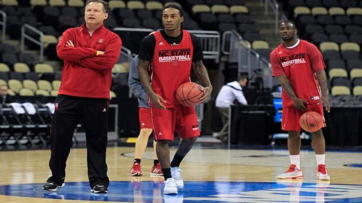 
N.C. State's head coach Mark Gottfried talks with Cat Barber (12) during N.C. State's open practice for the second round of the NCAA Division I Men's Basketball Tournament at the Consol Energy Center in Pittsburgh, Pa. Wednesday, March 18, 2015.
