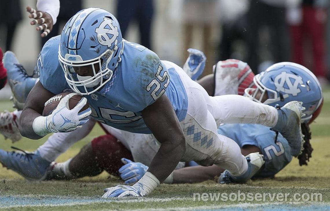 North Carolina’s Javonte Williams (25) scores on a rush in the third quarter against N.C. State on Saturday, November 24, 2018 at Kenan Stadium in Chapel Hill, N.C.