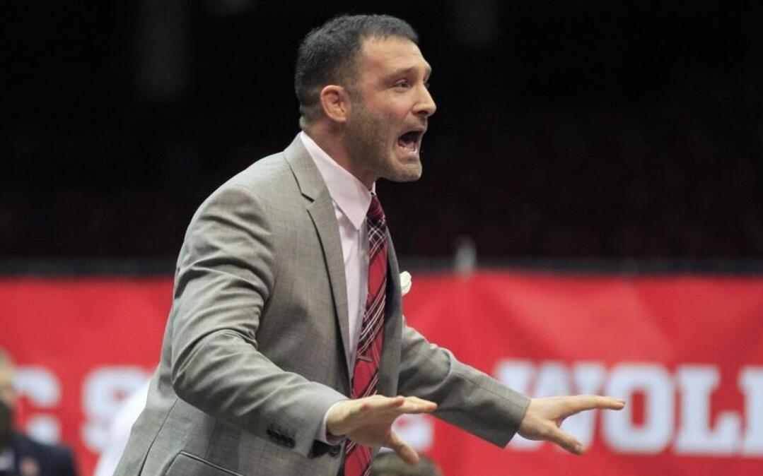 N.C. State head coach Pat Popolizio yells to his players during N.C. State's match against North Carolina in an ACC dual match at Dorton Arena in Raleigh, N.C., Monday, Jan. 25, 2016.