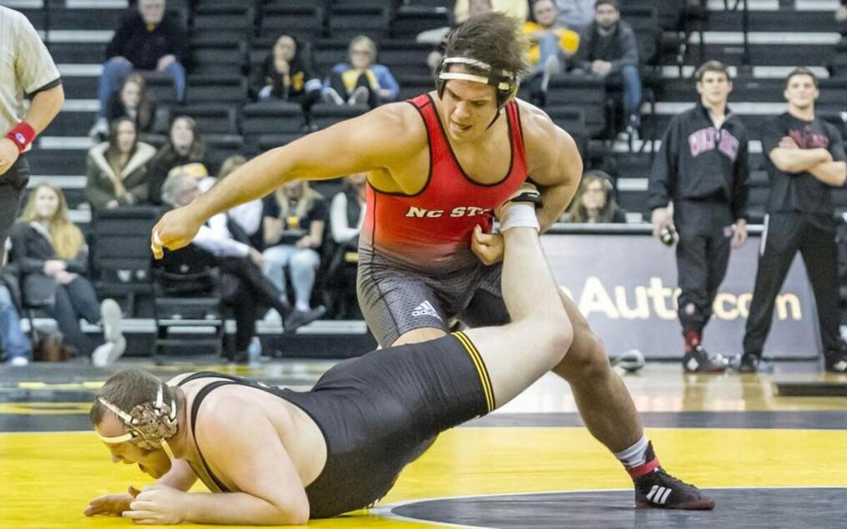 N.C. State's Nick Gwiazdowski defeated Iowa's Sam Stoll by injury default decision in the final match of the Wolfpack's 21-17 win.