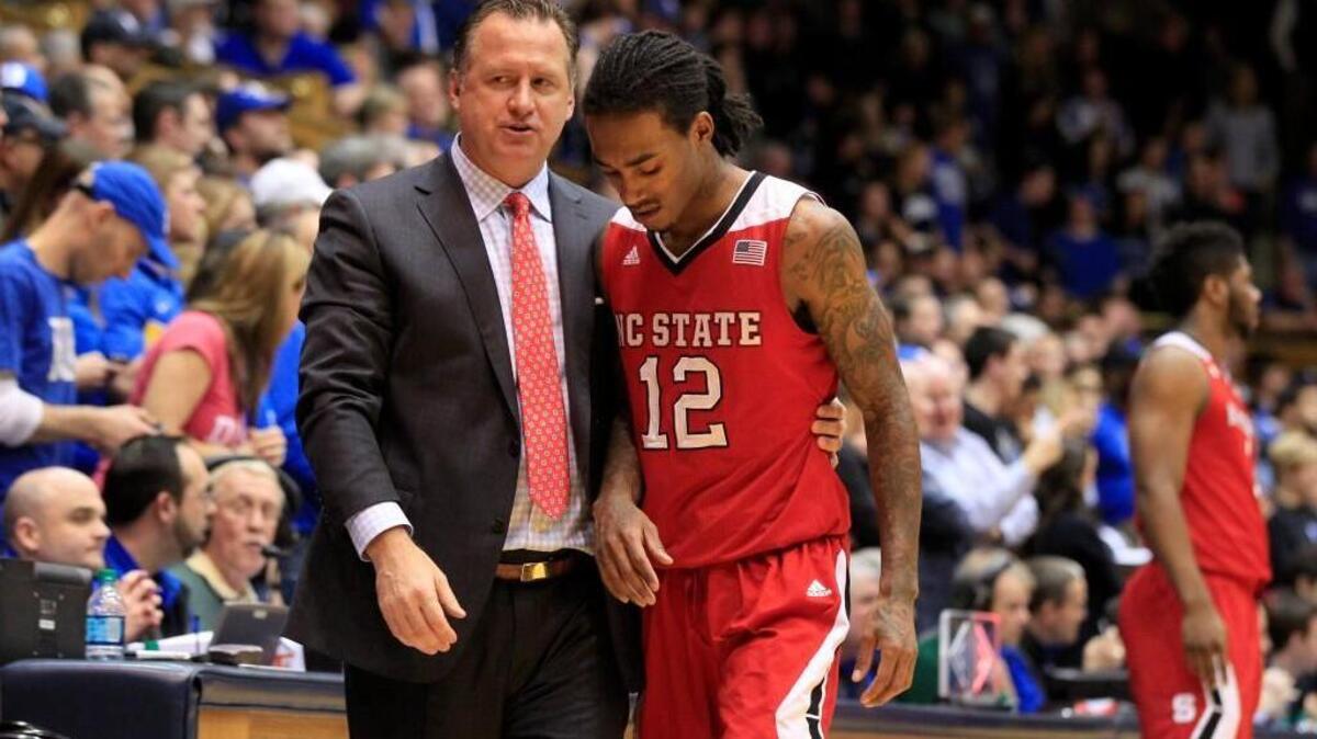 N.C. State head coach Mark Gottfried talks with Cat Barber (12) as Barber comes off the court after injuring his hand during the second half of Duke's 88-80 victory over N.C. State at Cameron Indoor Stadium Saturday, Feb. 6.