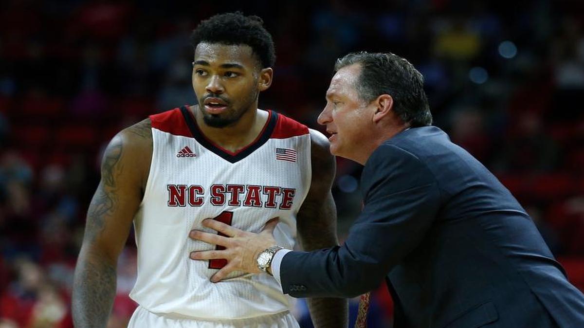
N.C. State head coach Mark Gottfried talks with Trevor Lacey (1) during the second half of N.C. State's 60-54 victory over Boise State at PNC Arena in Raleigh, N.C., Friday, Nov. 28, 2014.
