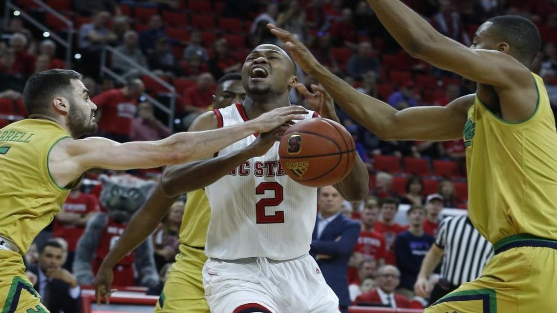 Notre Dame's Matt Farrell, left, knocks the ball from the hands of N.C. State's Torin Dorn during the first half at PNC Arena in Raleigh. Notre Dame's V.J. Beachem, right, also defends.