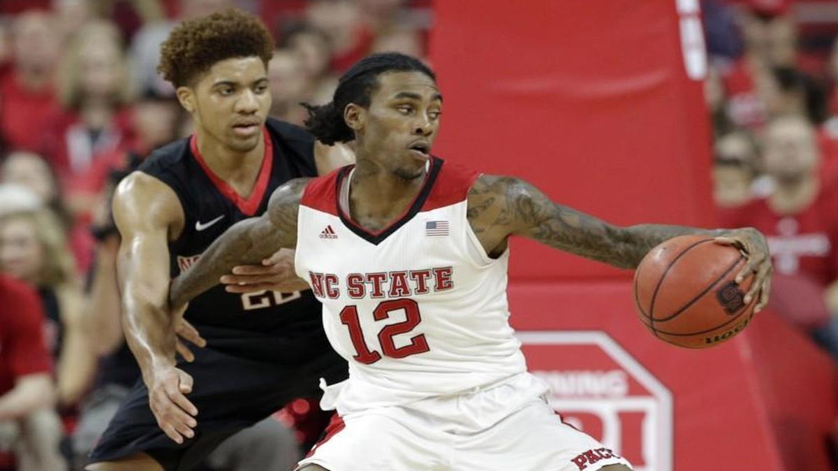N.C. State's Cat Barber is pressured by Northeastern's Donnell Gresham Jr. during the second half.
