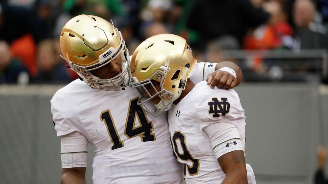 Notre Dame quarterback DeShone Kizer, left, talks to wide receiver Kevin Stepherson during game against Syracuse Saturday.(AP Photo/Julio Cortez)