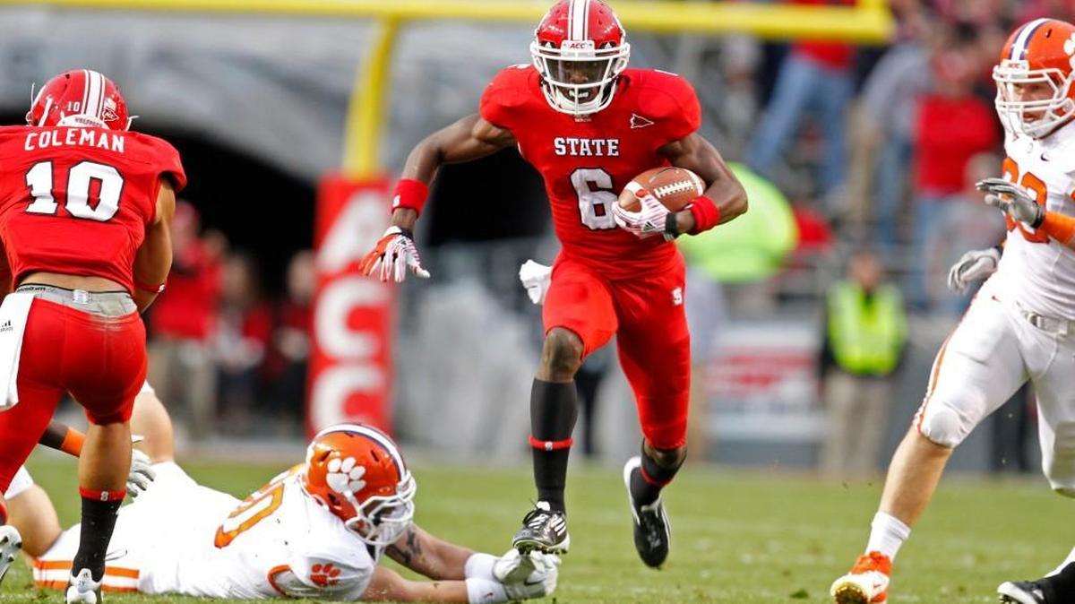 N.C. State's T.J. Graham (6) avoids Clemson's Chad Diehl (30) on a long punt return at Carter-Finley Stadium on Nov. 19, 2011.