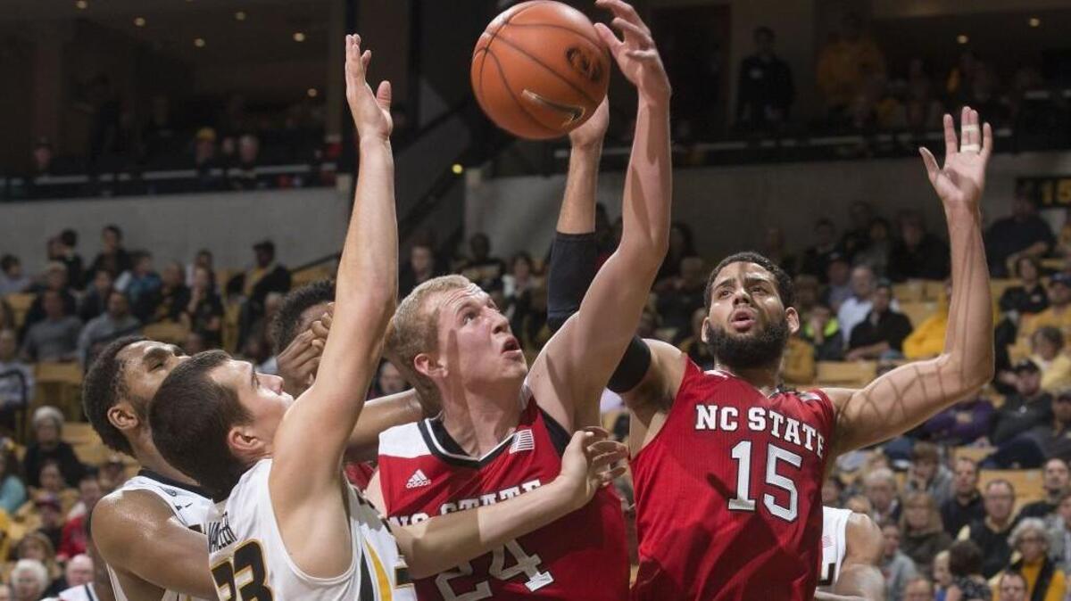 N.C. State’s Maverick Rowan, center, and Cody Martin, right, fend off Missouri's Kevin Puryear, far left, and Cullen VanLeer for a rebound during the Wolfpack’s 73-59 win over the Tigers on Dec. 19.