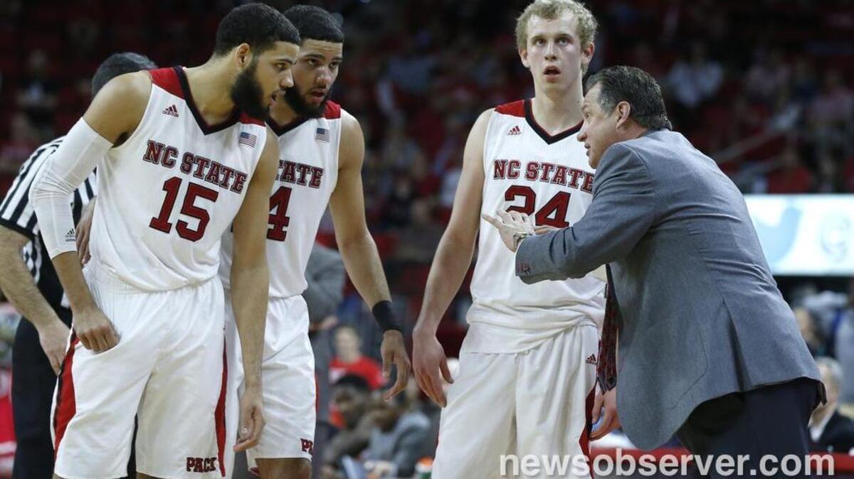 N.C. State coach Mark Gottfried talks with, from left, Cody Martin, Caleb Martin, and Maverick Rowan during the Wolfpack's 77-74 victory over Clemson at PNC Arena.