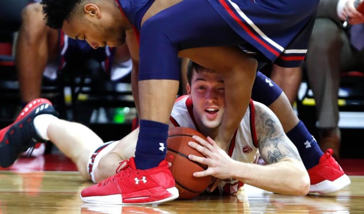 N.C. State's Braxton Beverly, bottom, pulls in a loose ball from Robert Morris guard Jon Williams on Dec. 19.