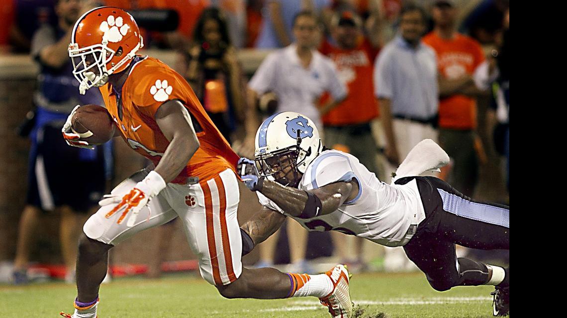 
Clemson's Artavis Scott (2) works his way to the end zone with a 33-yard touchdown reception past North Carolina's Sam Smiley in the fourth quarter at Memorial Stadium in Clemson, S.C., on Saturday, Sept. 27, 2014. Clemson won, 50-35.

