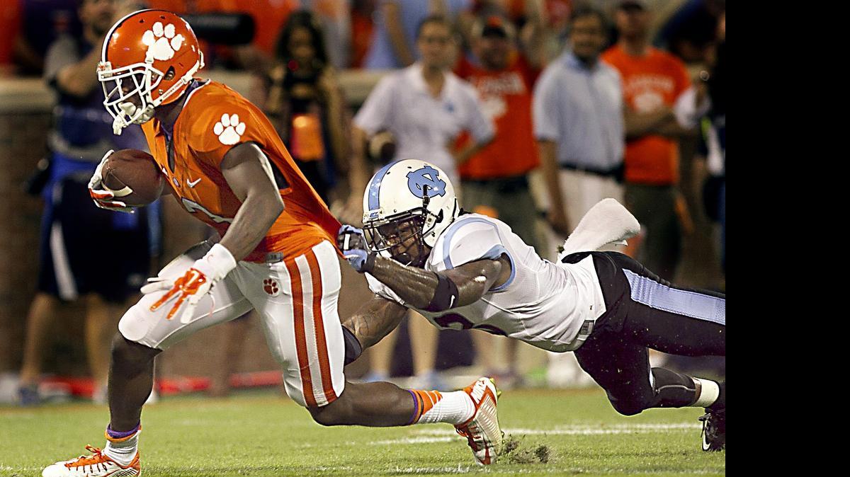 
Clemson's Artavis Scott (2) works his way to the end zone with a 33-yard touchdown reception past North Carolina's Sam Smiley in the fourth quarter at Memorial Stadium in Clemson, S.C., on Saturday, Sept. 27, 2014. Clemson won, 50-35.

