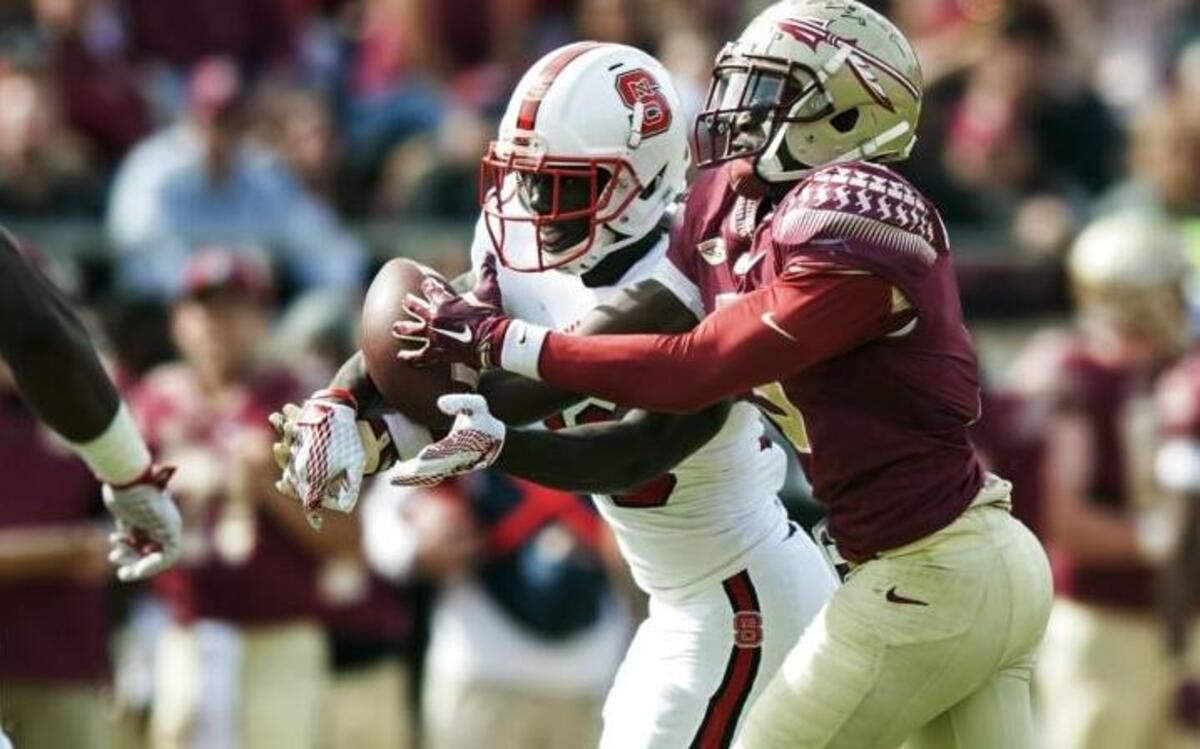N.C. State’s Jack Tocho (29) intercepts a pass intended for FSU’s Jesus Wilson (3) during the game at Doak Campbell Stadium in Tallahassee, Fa.