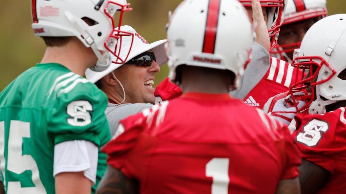 N.C. State offensive coordinator Eli Drinkwitz works with the offense in July.