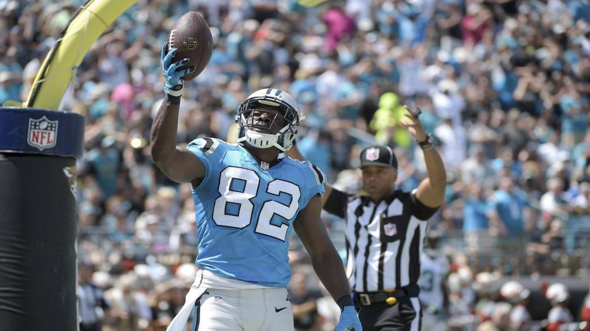 Carolina Panthers wide receiver Jerricho Cotchery (82) holds up the football in the end zone after one of his 34 career NFL touchdowns.