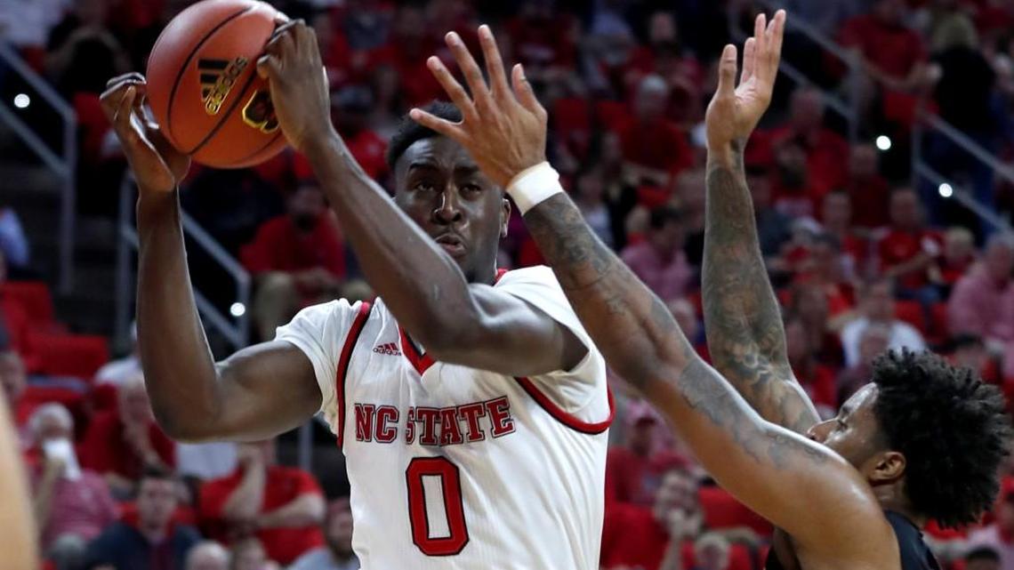 N.C. State's Abdul-Malik Abu (0) pulls in rebound from Florida State's Phil Cofer (0) during the first half of N.C. State's game against Florida State at PNC Arena in Raleigh, N.C., Sunday, Feb. 25, 2018.