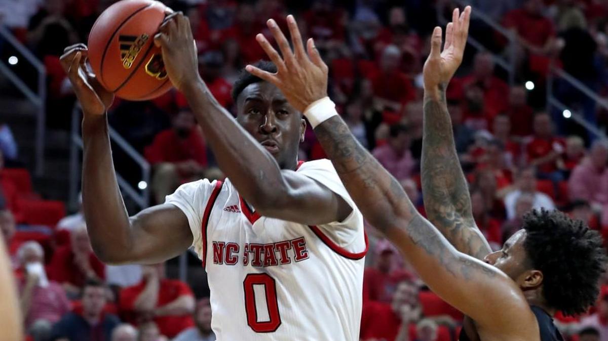 N.C. State's Abdul-Malik Abu (0) pulls in rebound from Florida State's Phil Cofer (0) during the first half of N.C. State's game against Florida State at PNC Arena in Raleigh, N.C., Sunday, Feb. 25, 2018.