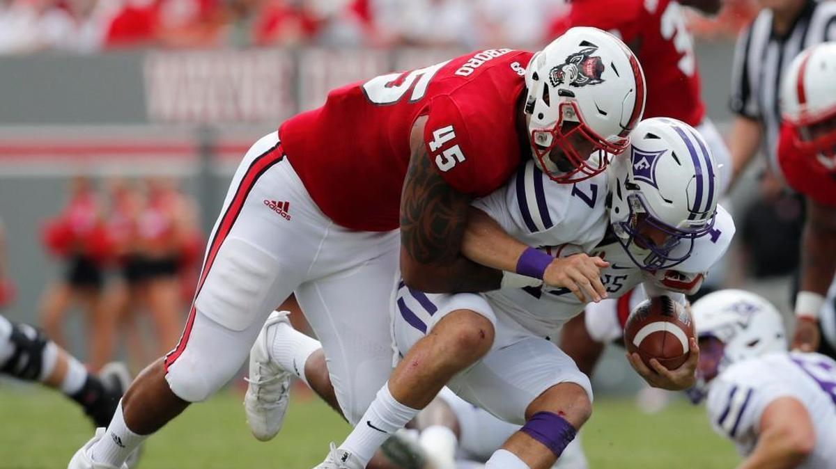 N.C. State defensive end Darian Roseboro (45) sacks Furman quarterback P.J. Blazejowski (7) during the first half of N.C. State's game against Furman at Carter-Finley Stadium on Sept. 16, 2017.