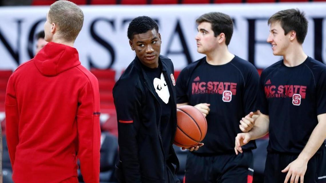 N.C. State's Markell Johnson, center, did not dress for the Wolfpack's game against UNCG on Dec. 16. The school announced before the game that Johnson had been suspended from the team.
