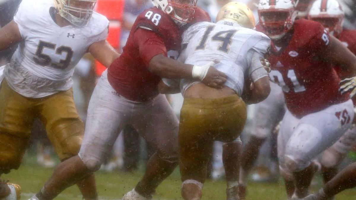 N.C. State defensive tackle B.J. Hill (98) stops Notre Dame quarterback DeShone Kizer (14) for no gain during the second half of N.C. State's 10-3 victory over Notre Dame at Carter-Finley Stadium Saturday.