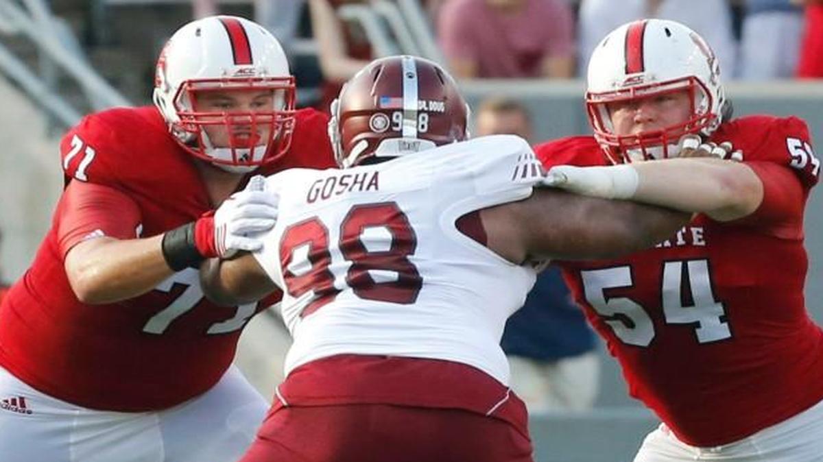
N.C. State's Alex Barr (71) and Joe Thuney (54) block Troy defensive lineman Lonnie Gosha (98) to give quarterback Jacoby Brissett (12) time to pass during the Wolfpack's game against Troy at Carter-Finley Stadium in Raleigh Saturday, Sept. 5, 2015.

