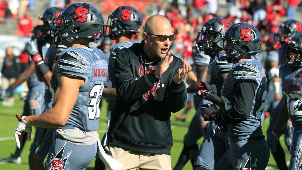 N.C. State offensive coordinator Matt Canada encourages the team during warmups before the Wolfpack's game against Syracuse at Carter-Finley Stadium in Raleigh.