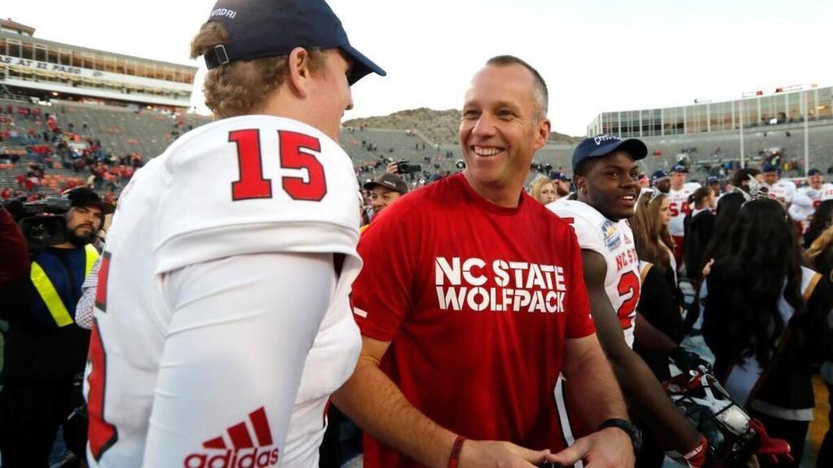 N.C. State head coach Dave Doeren (right) has a few more reasons to smile with his new five-year contract.