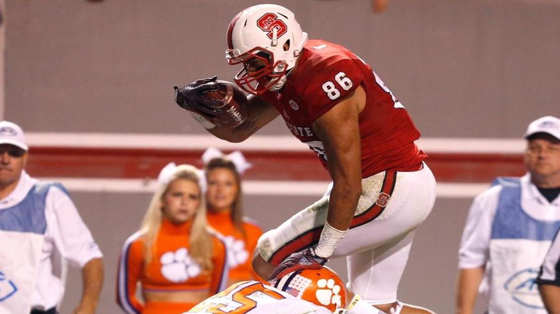 N.C. State's David J. Grinnage (86) hurdles over Clemson's Cordrea Tankersley (25) during the second half of Clemson's 56-41 victory over N.C. State at Carter-Finley Stadium in October.