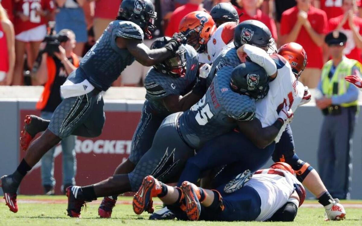 On fourth and one with 7:47 left in the second quarter, N.C. State’s Kentavius Street (35) and the defense stop Syracuse quarterback Eric Dungey (2) for no gain during the Wolfpack’s victory at Carter-Finley Stadium in Raleigh Saturday, Sept. 30, 2017.