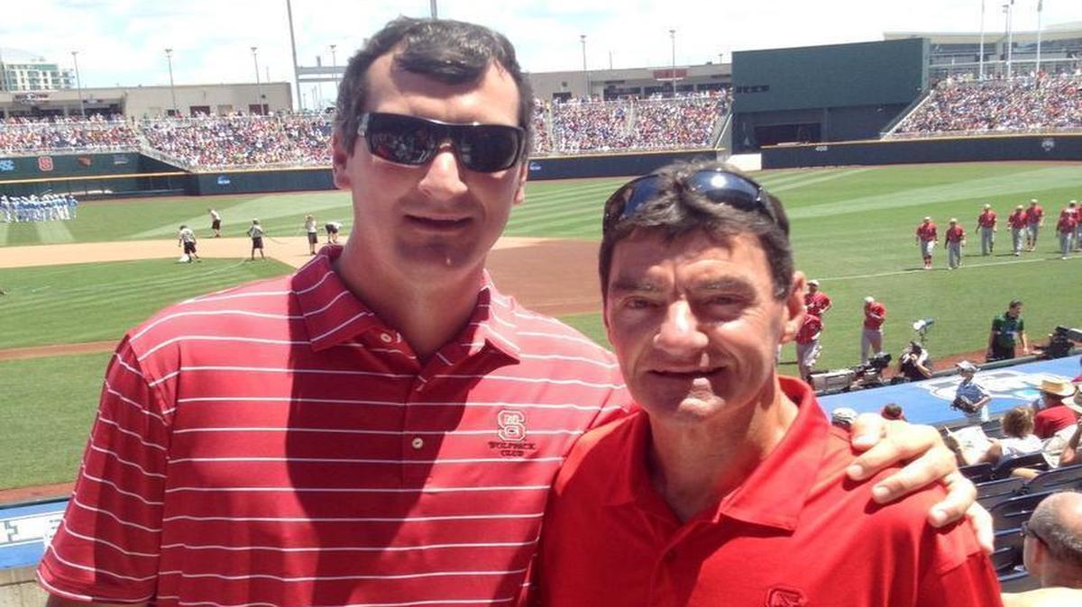 Francis Combs and his son, Chris, pose together during the College World Series in Omaha, Nebraska in 2013.
