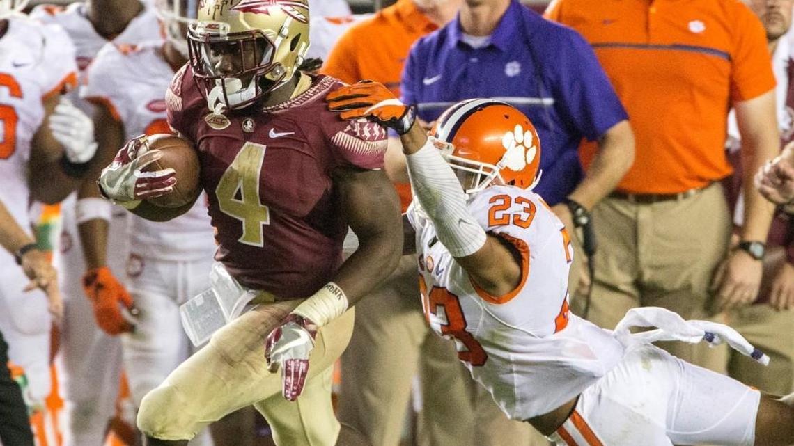 Florida State running back Dalvin Cook sheds Clemson safety Van Smith during a touchdown run on Nov. 26. The Seminoles are the preseason favorite to win the ACC football championship. The Tigers are in the No. 2 spot.