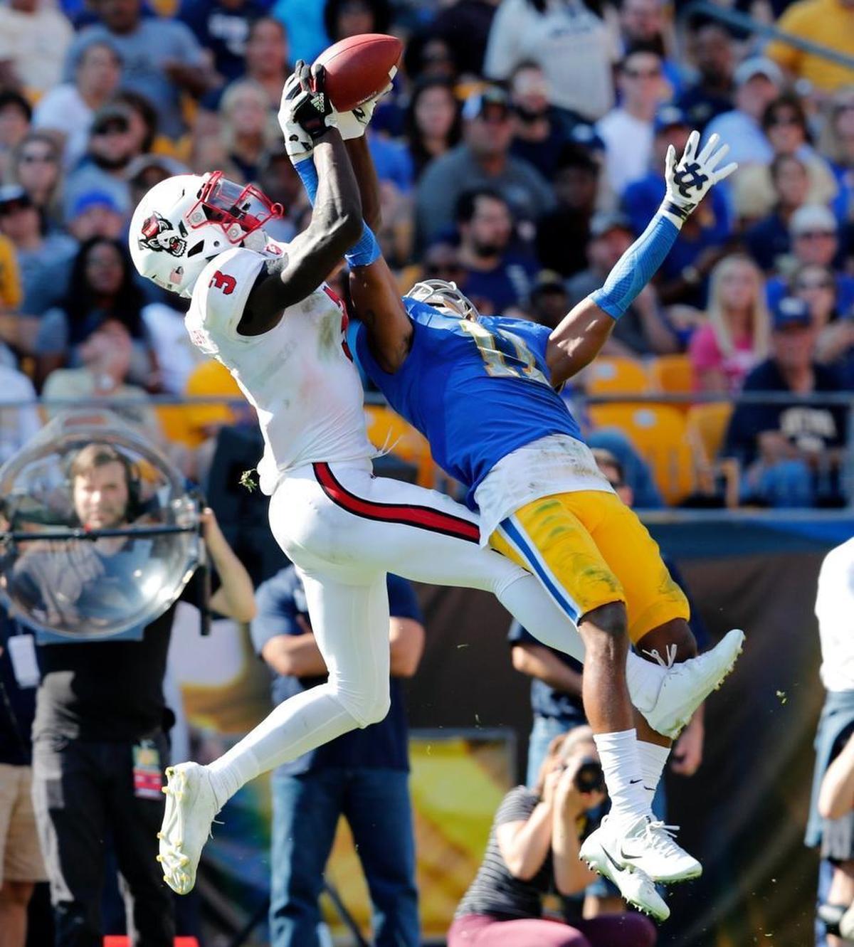 N.C. State wide receiver Kelvin Harmon (3) beats Pitt defensive back Dane Jackson (11) for a reception during the second half of N.C. State's 35-17 victory over Pittsburgh at Heinz Field in Pittsburgh on Oct .14, 2017.