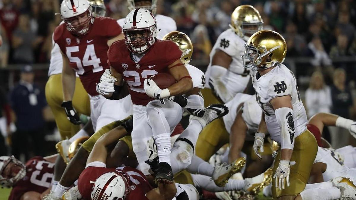 Stanford running back Cameron Scarlett, middle, runs for a touchdown against Notre Dame on Saturday. The Cardinal won 38-20.s