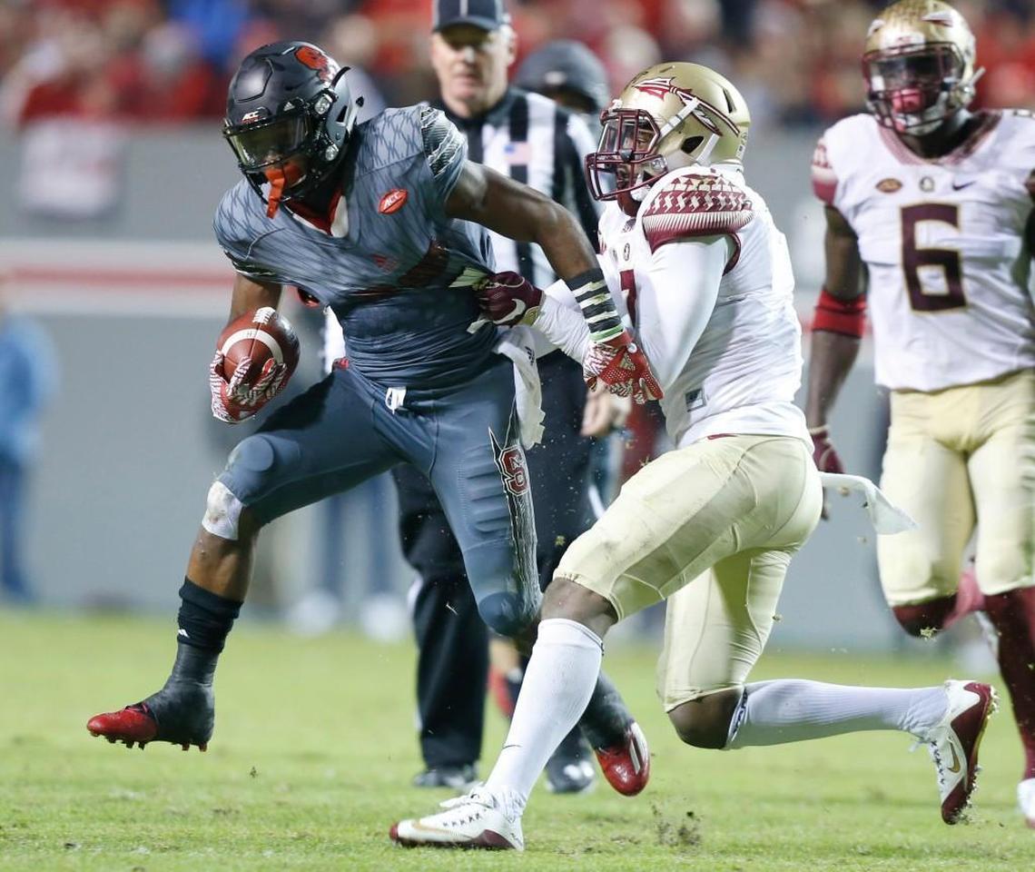 Nyheim Hines, left, escapes from Florida State’s Ermon Lane (7) in November.