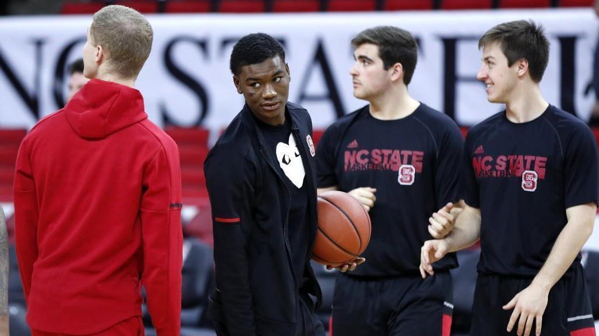 N.C. State’s Markell Johnson, center, is not dressed for the Wolfpack’s game against UNCG on Dec. 16.