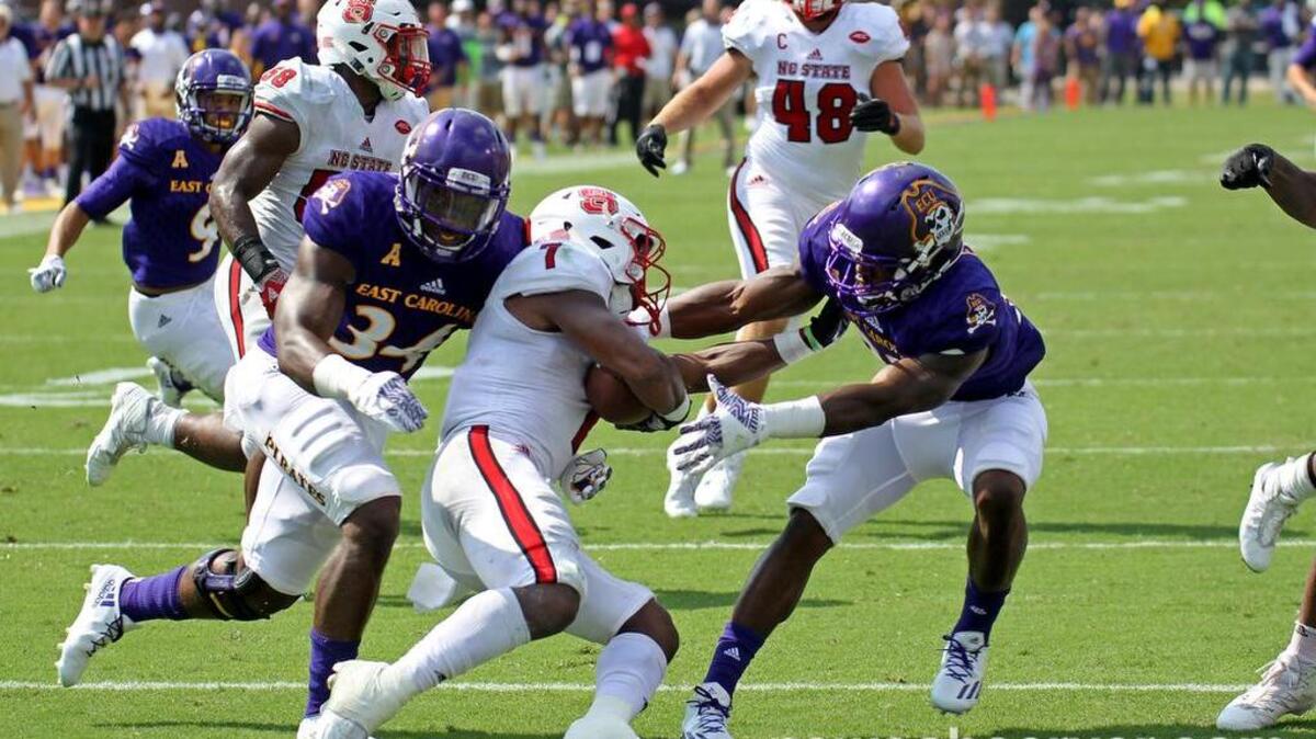 East Carolina linebacker Devaris Brunson (34) and East Carolina running back Shawn Furlow (33) tackle N.C. State running back Nyheim Hines (7) on the 4-yard line during a kickoff at Dowdy-Ficklen Stadium in Greenville on Sept. 10, 2016.