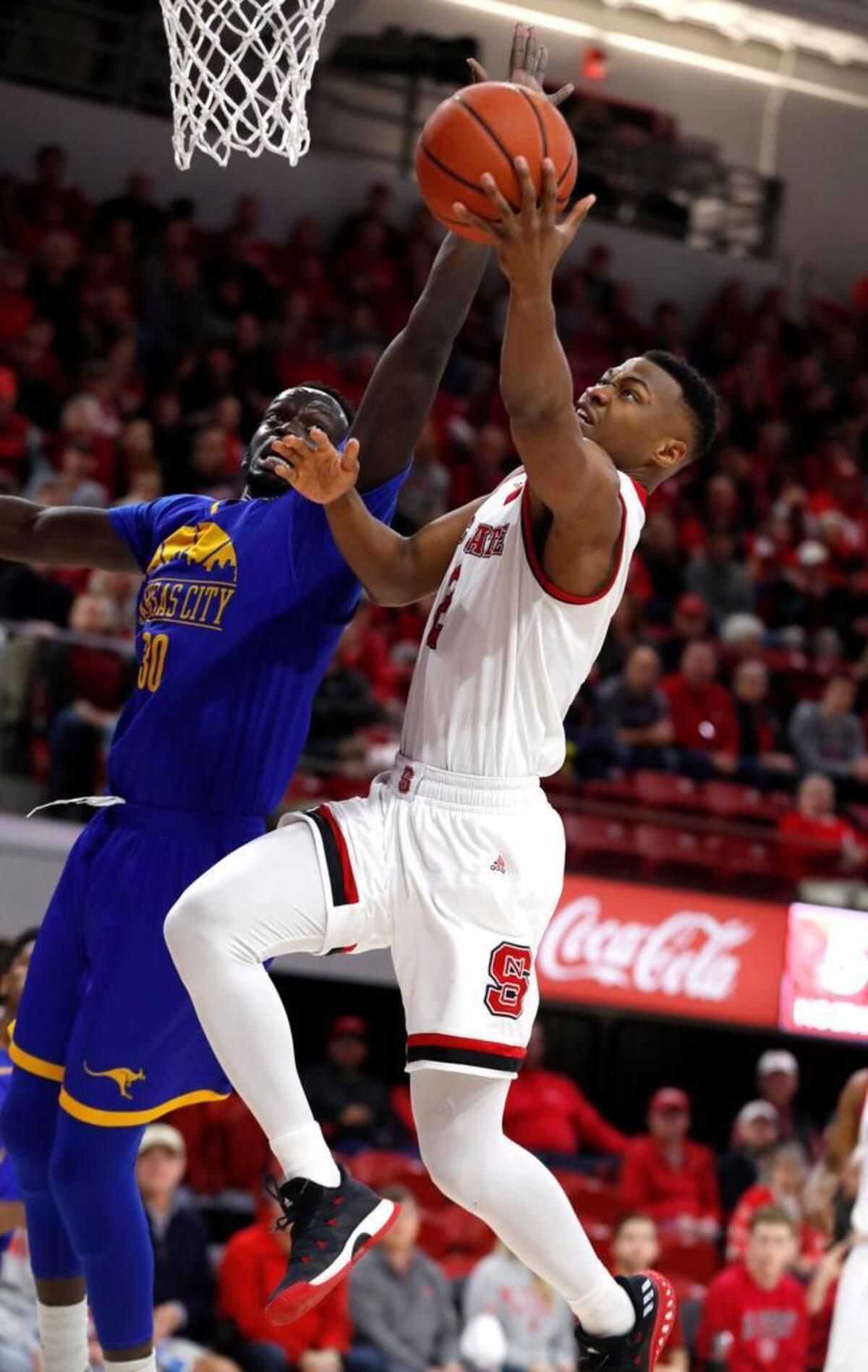 N.C. State's Torin Dorn (2) drives to the basket as UMKC's Aleer Leek (30) defends at Reynolds Coliseum Saturday, Dec. 9, 2017.
