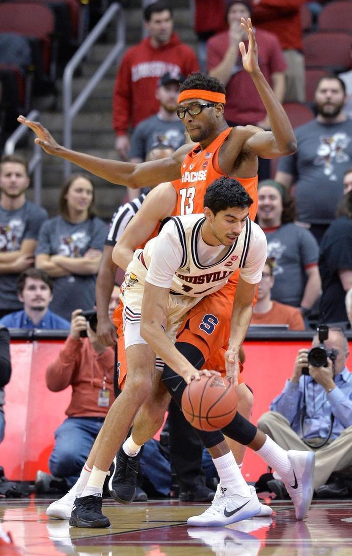 Louisville forward Anas Mahmoud (14) attempts to fight his way around the defense of Syracuse center Paschal Chukwu (13) during the first half on Feb. 5, 2018, in Louisville, Ky. (AP Photo/Timothy D. Easley)