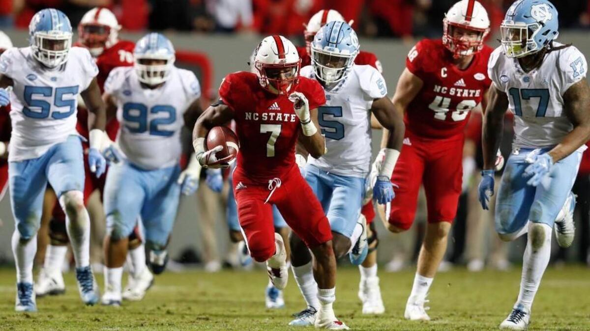 N.C. State Nyheim Hines, middle, outruns the North Carolina defense on his way to scoring on a 48-yard touchdown on Nov. 25.