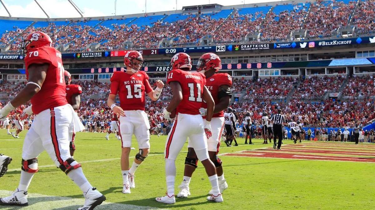 N.C. State quarterback Ryan Finley (15), left, and Tyler Jones (53) congratulate Jakobi Meyers (11) after Meyers scored on a four-yard touchdown reception in the first half of the Wolfpack's game against South Carolina in the Belk College Kickoff at Bank of America Stadium in Charlotte on Sept. 2, 2017.