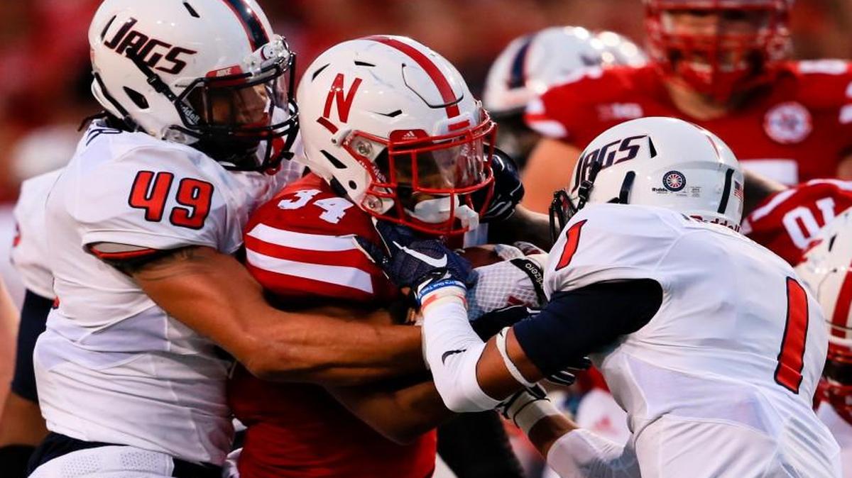 
Nebraska running back Terrell Newby (34) is tackled by South Alabama linebacker Demarius Rancifer (49) and cornerback Jalen Thompson (1) during the first half of an NCAA college football game in Lincoln, Neb., Saturday, Sept. 12, 2015. 
