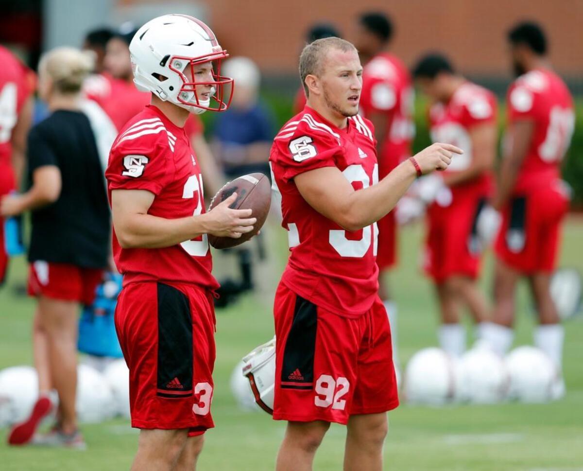 N.C. State's Kyle Bambard (92), right, talks with Carson Wise (38) during the Wolfpack's first practice of fall camp at the Curtis and Jacqueline Dail Football Practice Complex on July 29, 2017.