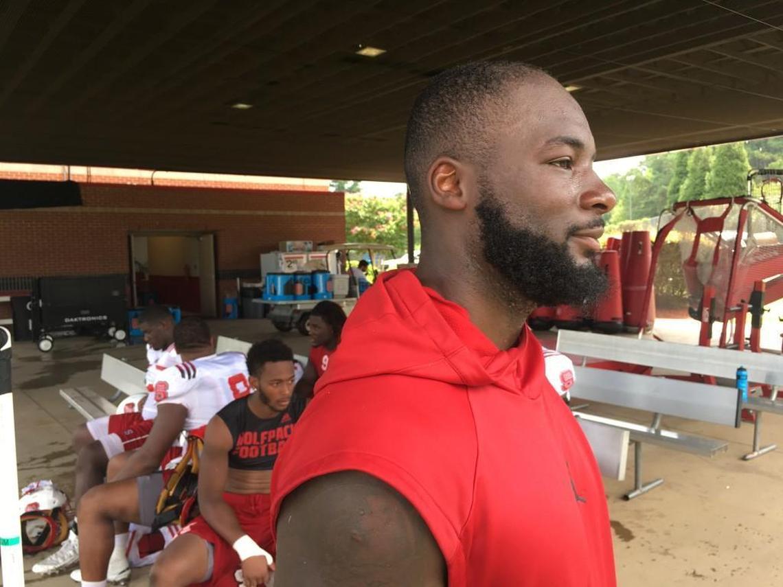 N.C. State's Germaine Pratt talks after practice on August 17, 2017. Pratt wears a sleeveless hooded sweatshirt all the time, even under his shoulder pads during practice.