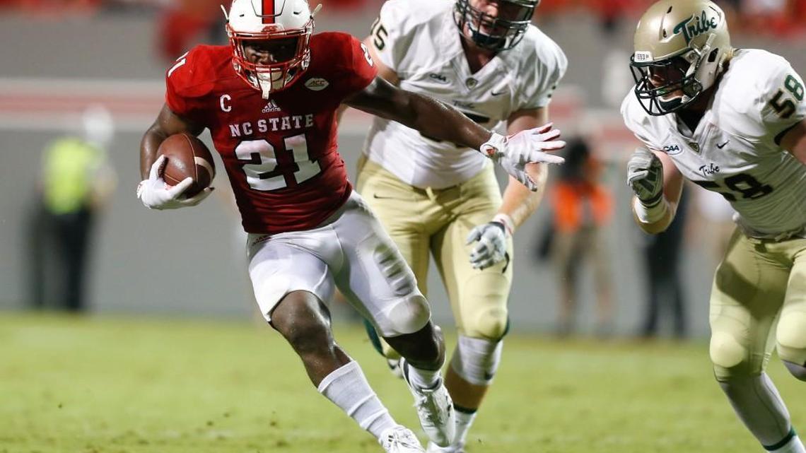 N.C. State running back Matthew Dayes (21) gains yards as William & Mary's defensive end Matt Ahola (58) closes in during the first half of the Wolfpack's game against William & Mary at Carter-Finley Stadium Thursday.